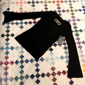 Black V-Neck Sweater with Gold chain accent.